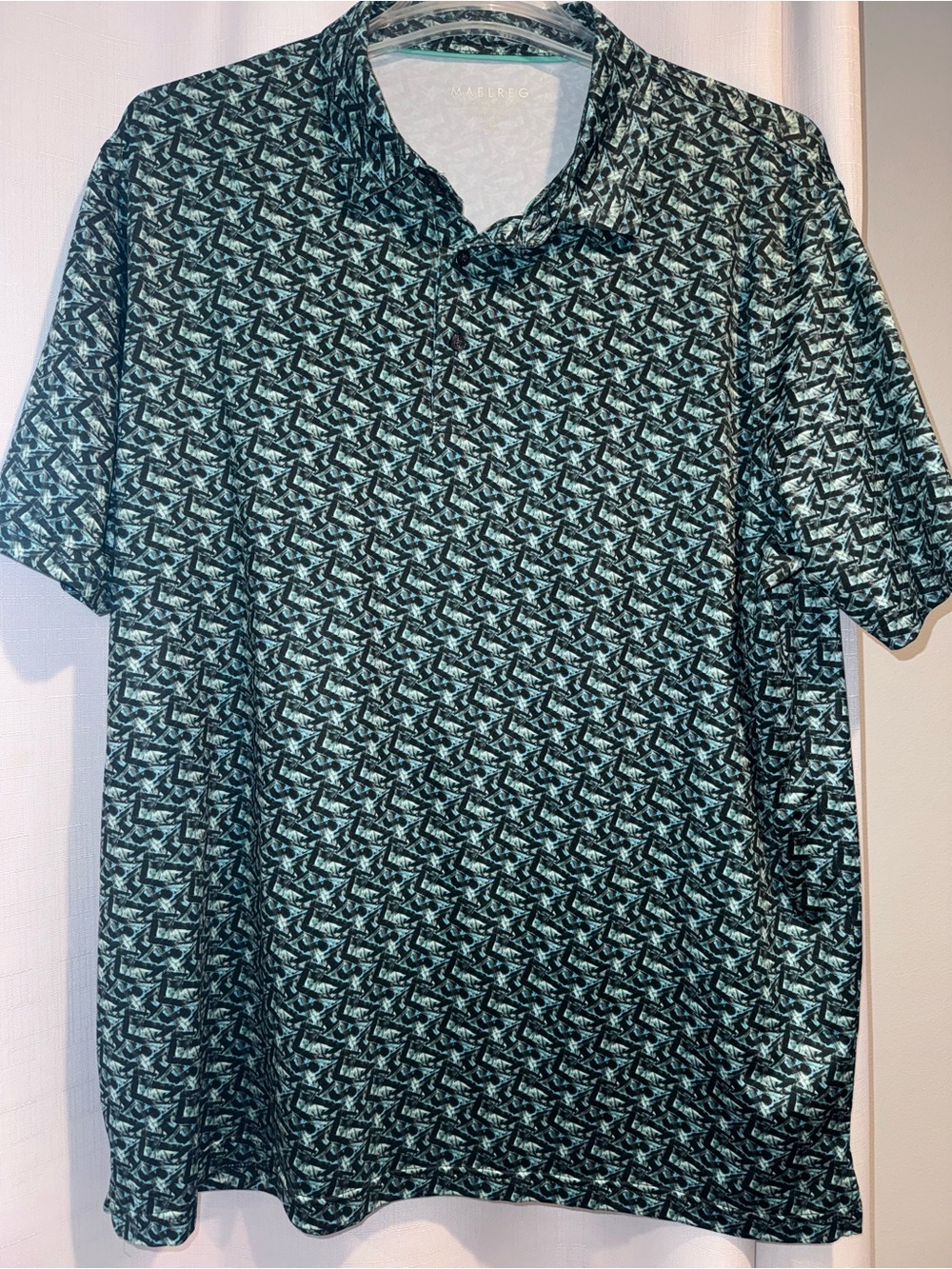MAELREG Performance Polo in Black & Green Aqua Geometric Print